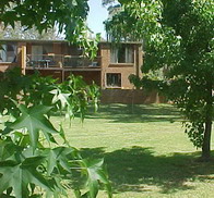 Manicured lawns looking up the small hill to the main building